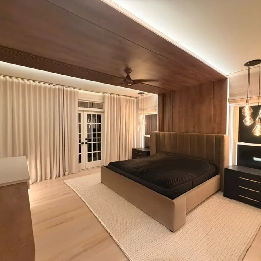 Primary bedroom remodel with a wood ceiling panel, LED cove lighting and maple floors